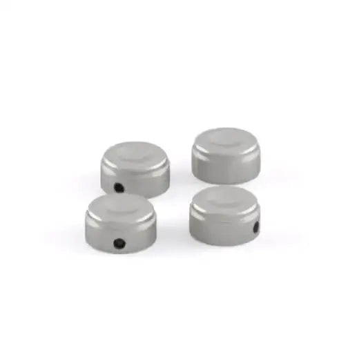 Silver metallic cylindrical triumph topplokkboltdeksler klar with circular indentations for original triumph speed twin