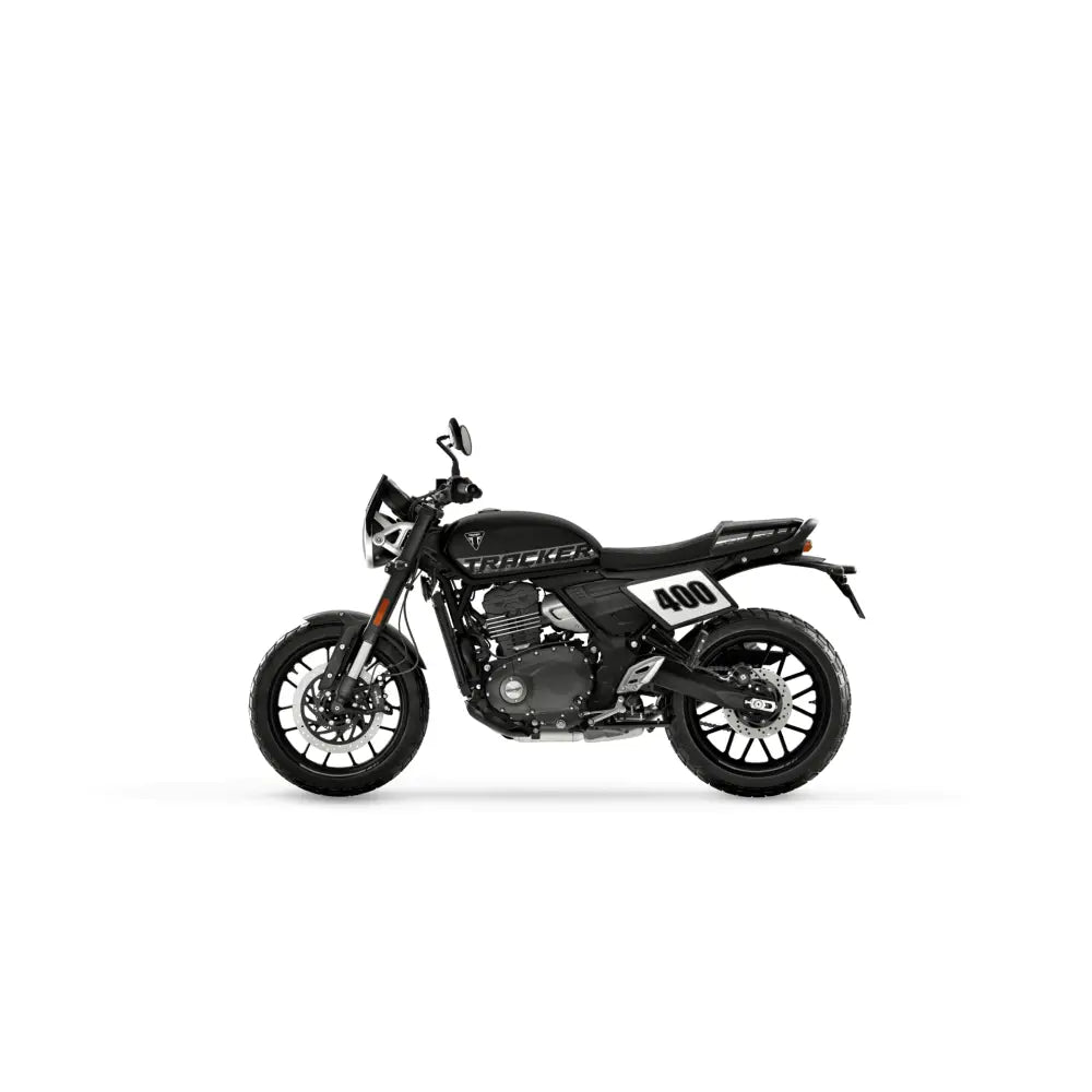 Black triumph tracker 400 2026 with white racing number decals chrome accents and pirelli mt60 tires modern classic motorcycle